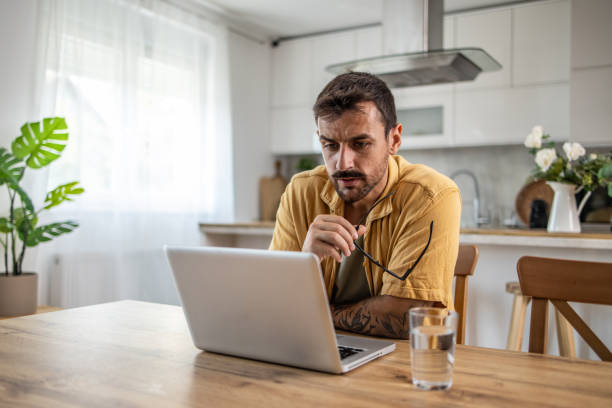 istock Productive adult man working from home, engaged with apps and software on laptop 2189658395