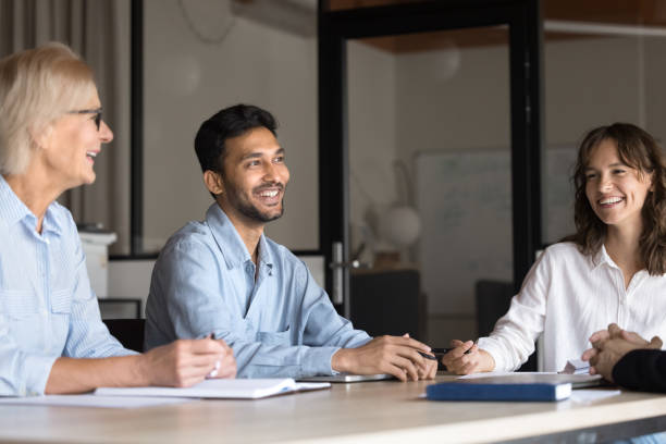 istock Happy teammates lead informal talk seated at conference table 2189659302