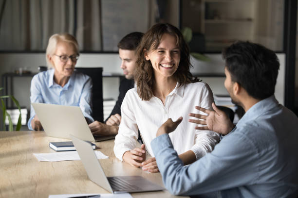 istock Multiethnic happy teammates sit at desk lead talk and laughing 2189660000