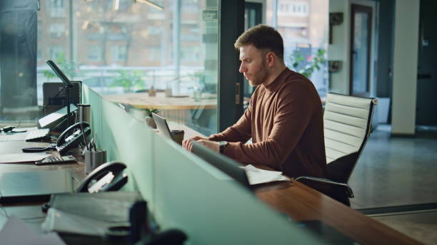 istock Office manager closing computer lid finish online research at corporate interior 2189662217