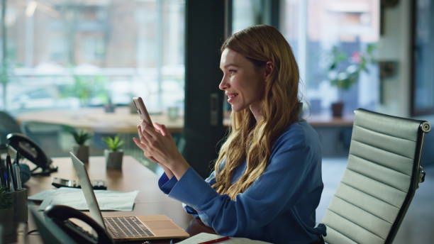 istock Office employee browsing cellphone social media content at work break closeup. 2189662865