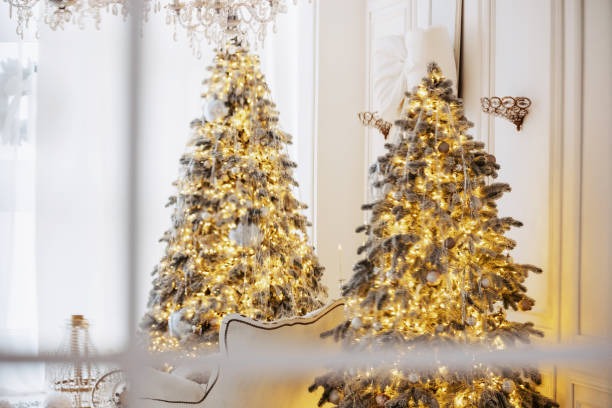 istock Festive Christmas trees decked with lights and ornaments 2189664109