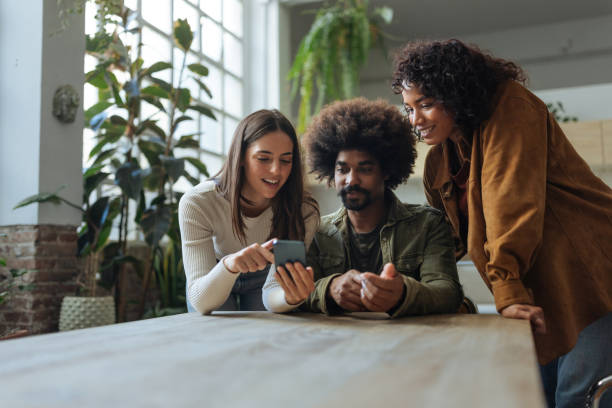 istock Young entrepreneurs looking at a smartphone in their office 2189664150