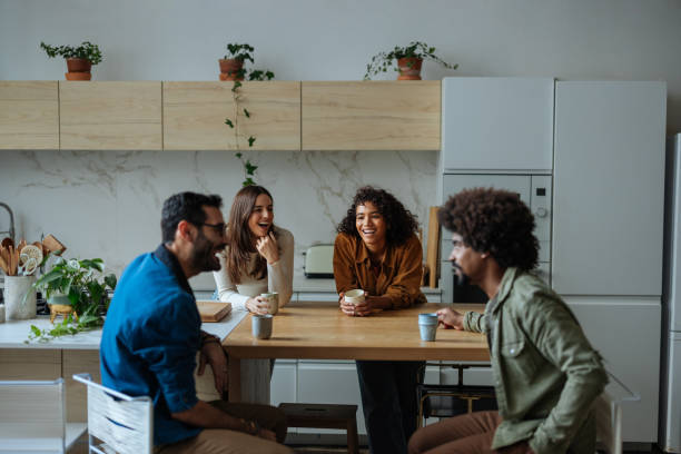 istock Cheerful friends laughing and talking together in the kitchen 2189664180
