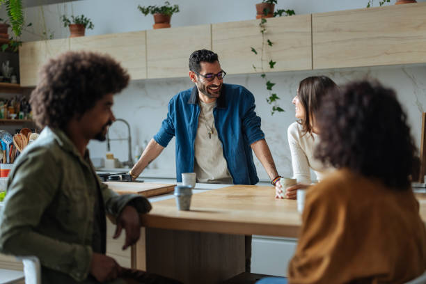 istock Cheerful friends chatting and having coffee in a modern kitchen 2189664195
