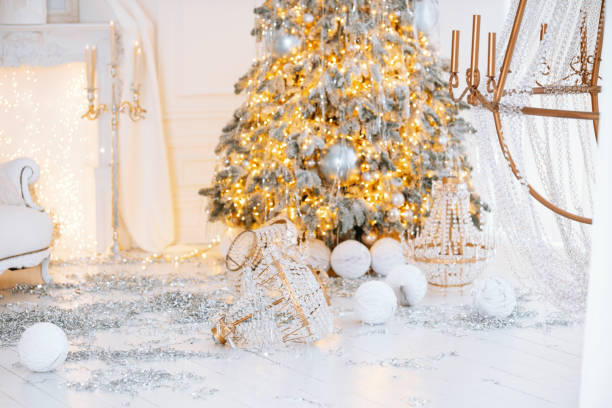 istock Festive Christmas decorations with a beautifully lit tree and gift boxes 2189664216