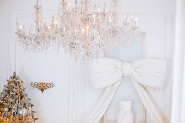 istock Elegant Christmas decor with tree, chandelier, and festive bow in winter setting 2189664220