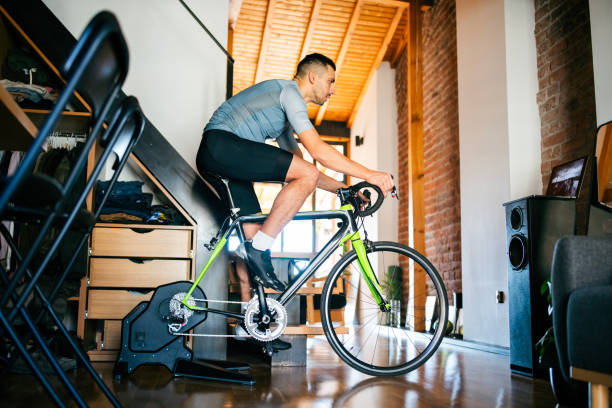 istock Man working out on his indoors cycling turbo trainer 2189664260