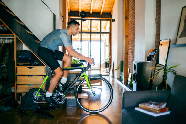 istock Man working out on his indoors cycling turbo trainer 2189664261