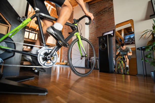 istock Man working out on his indoors cycling turbo trainer 2189664282