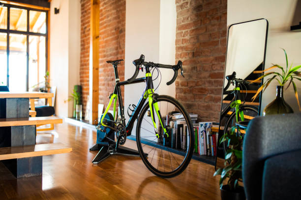 istock Road bike on smart trainer at home interior. 2189664287