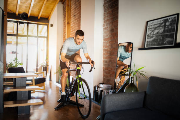 Man working out on his indoors cycling turbo trainer