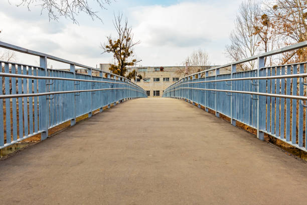 Empty footbridge with metal railings. New pedestrian bridge
