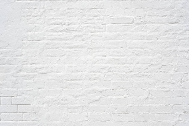An old but freshly painted white brick wall