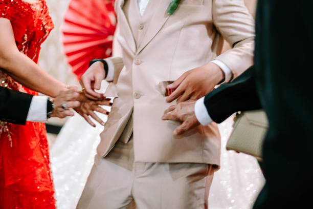 istock A man placing a red envelope with Chinese symbols into his pocket, 2189672091