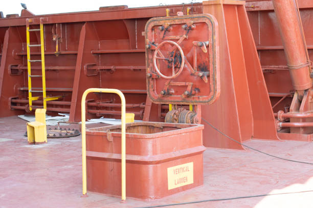cargo hold entance with vertical ladder booby hatch of a bulk carrier ship with hatch coaming