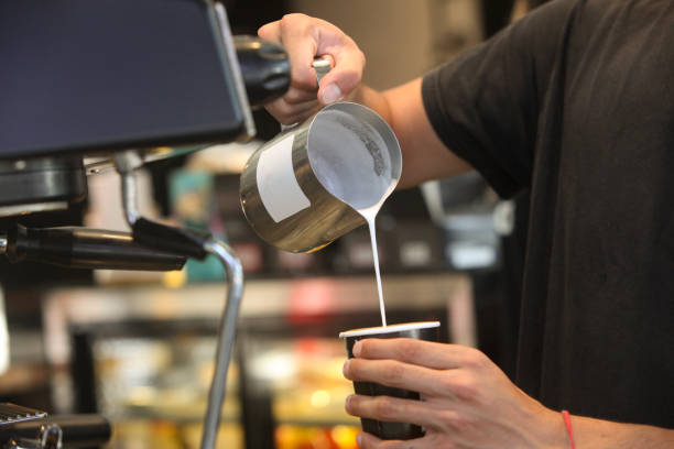 hands of barista making coffee in cafe