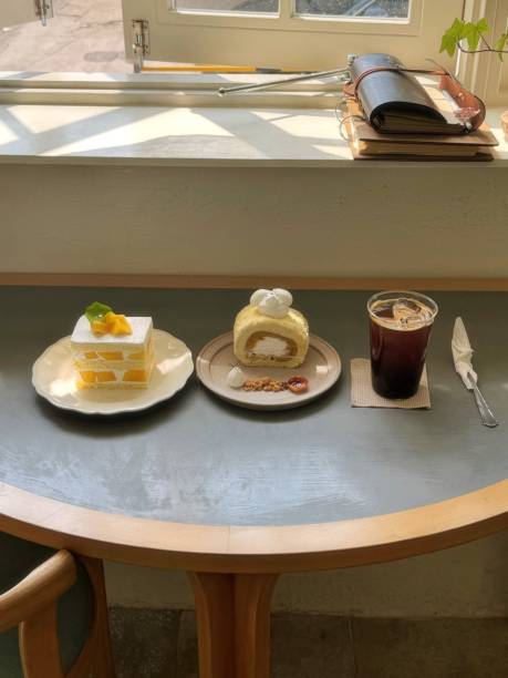 A delightful assortment of desserts displayed in a cozy cafe setting, featuring cakes, pastries, and sweet treats on elegant plates, creating a warm and inviting atmosphere.