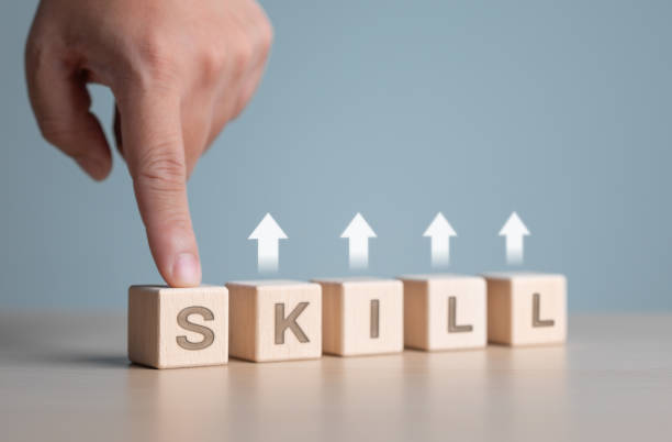 istock Hand point on wooden cubes with the word SKILL and arrow up icons. Upskill training, knowledge and education, learning ability. Up-skilling, Re-skilling. Upskilling and personal expertise development. 2189694187