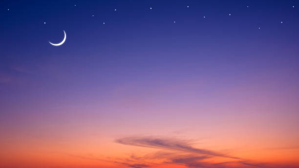 istock Night sky Ramadan background with crescent moon and star on dramatic dark blue orange twilight sky with copy space 2189696522