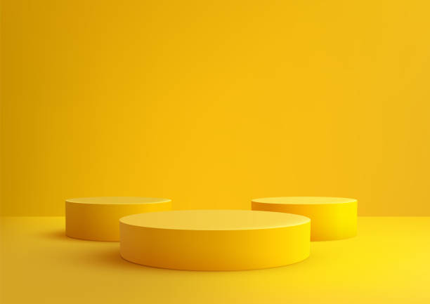 istock Bright Yellow 3D Cylindrical Podiums on Yellow Background for Product Display Mockup 2189700402