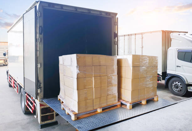 istock Bulk of Package Boxes Loading into Delivery Truck. Forklift Pallet Jack. Container Shipping. Supply Chain, Supplies Shipment Goods, Distribution. Freight Truck Logistics Cargo Transportation. 2189701201