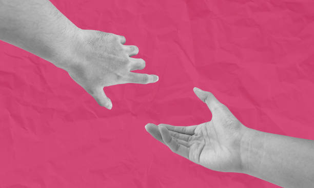 istock Hand reaching out diagonally, isolated on pink background 2189704815