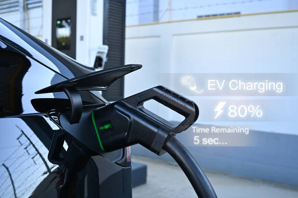 istock Electric vehicle charging at station with digital interface displaying charging progress and time remaining 2189709784