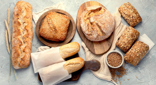 istock Various types of fresh baked bread on light gray background. 2189711428