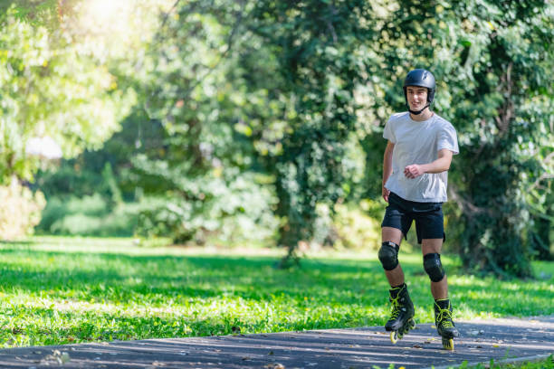 Young man rollerblading outdoors in a park, showcasing agility and energy. This vibrant scene highlights fitness, outdoor fun, and an active lifestyle in a natural park environment
