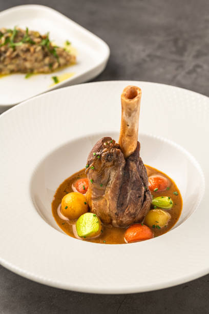 istock Traditional slow-cooked braised lamb knuckle or lamb shank with sauces 2189718683