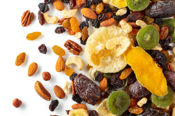 istock Dried tropical fruits, nuts, and raisins isolated on white. 2189719362