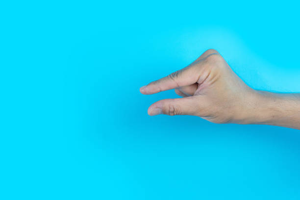 istock man hand make a little bit gesture on a blue background 2189721417