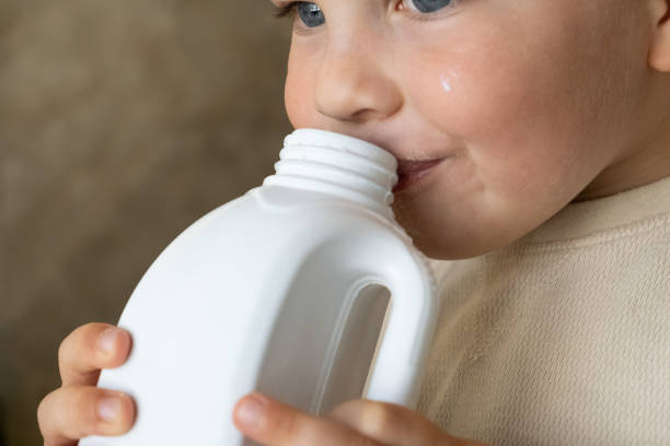 istock A boy takes a sip of milk from a white bottle 2189721777