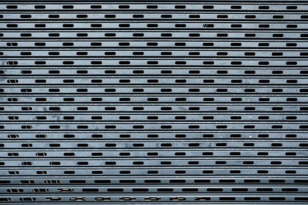 Blue metal roll-up garage door with perforations.