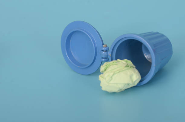 Stock photo showing close-up view of a blue baby dummy (pacifier) and white teddy bear against a blue background. Male coded childcare concept.