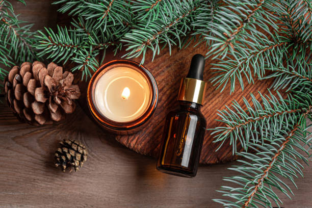 Fir or pine essential oil dropper and aroma candle