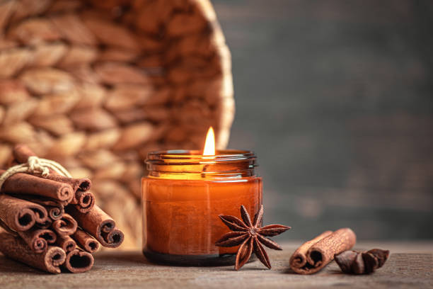 scented burning candle with cinnamon and anise