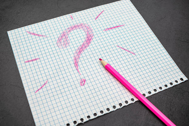 Drawing of a happy smiling emoticon on a white paper and gray background.