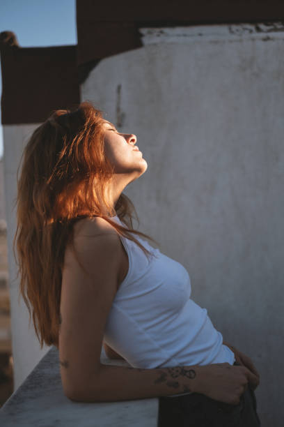 istock Attractive Young Redhead Woman on a Rooftop 2189728790