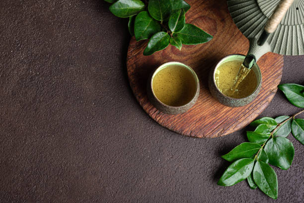 Pouring green tea into cups