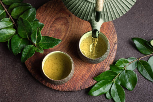 istock Pouring green tea into cups 2189728948