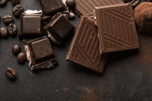 istock Delicious chocolates and spices on a black background. 2189730026