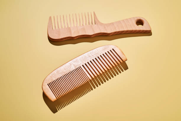 istock Two wooden combs on a yellow background. 2189732737