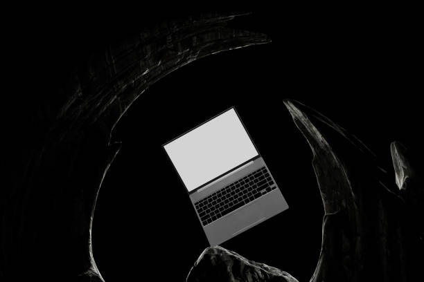 istock A laptop is laying on its side on a dark surface 2189733351