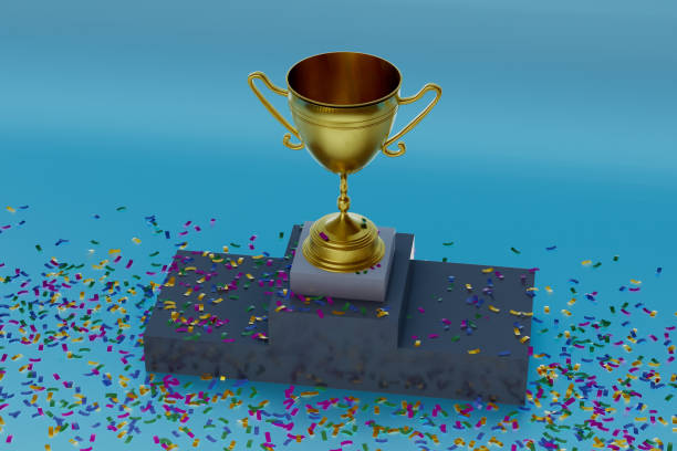 istock A gold cup with a gold handle sits on a podium with colorful confetti around it 2189733708