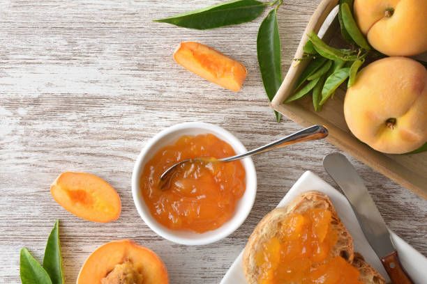 istock Toast prepared with peach jam and tray with fruit 2189735921