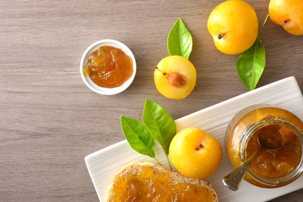 istock Plum jam and pieces of fruit on a wooden table 2189735929