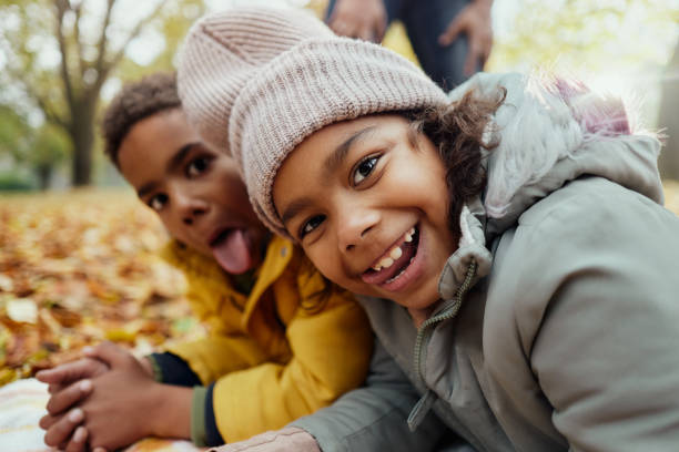 istock Happy black siblings having fun in autumn day. 2189736524