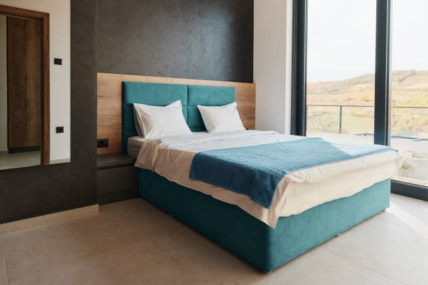 3d rendering of spacious bedroom with cozy box-spring bed at night